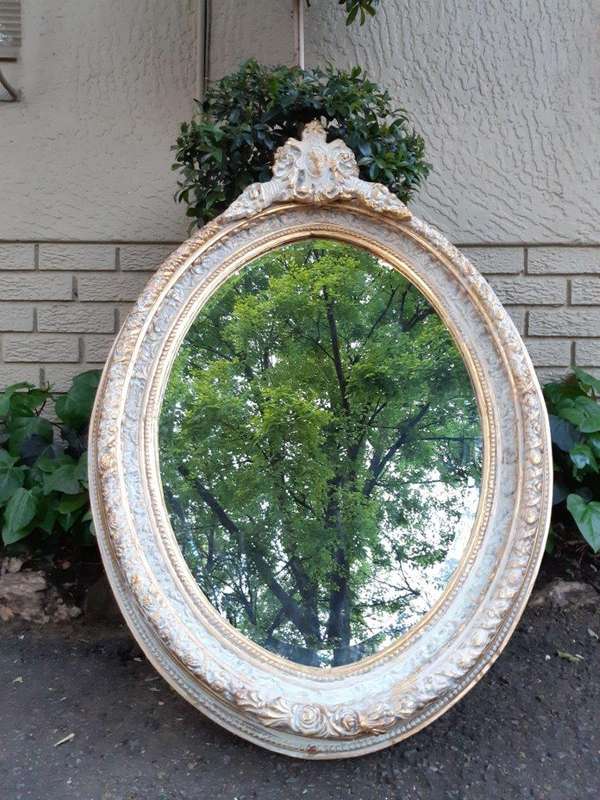 An Oval Ornate Bevelled Mirror