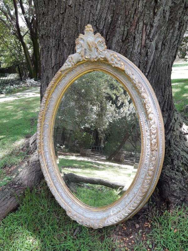 An Oval Ornate Bevelled Mirror