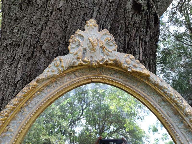 An Oval Ornate Bevelled Mirror