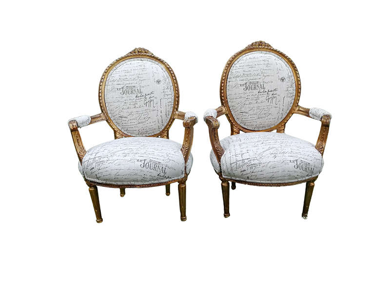 A Pair of French Style Carved and Gilded Armchairs Upholstered in a Custom-made Script on Linen F...
