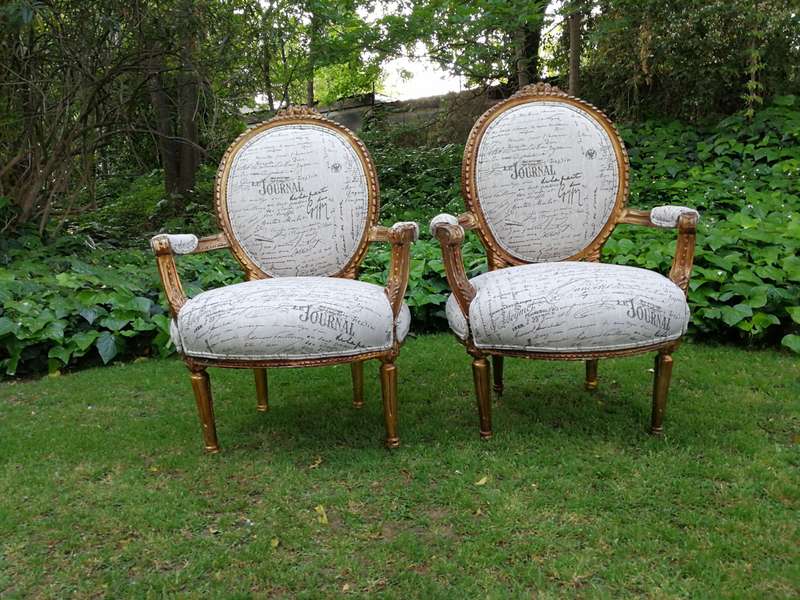 A Pair of French Style Carved and Gilded Armchairs Upholstered in a Custom-made Script on Linen F...