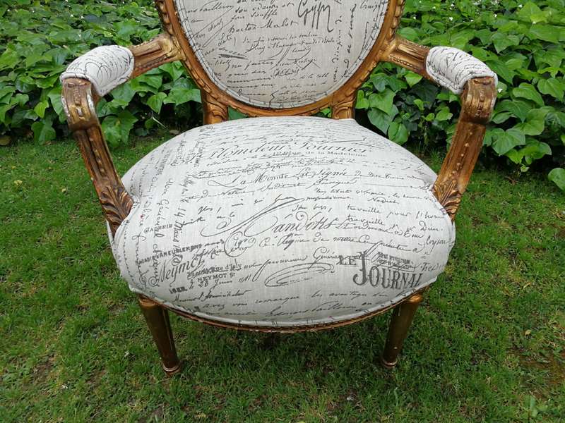 A Pair of French Style Carved and Gilded Armchairs Upholstered in a Custom-made Script on Linen F...