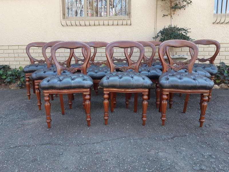 A 20TH Century Set of Twelve Victorian Style Mahogany Bustle Back Dining Chairs Upholstered in De...