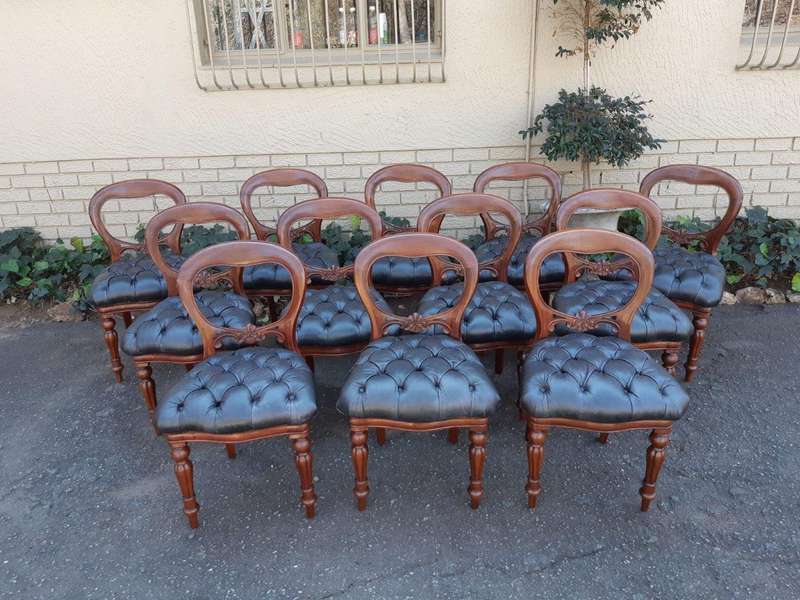 A 20TH Century Set of Twelve Victorian Style Mahogany Bustle Back Dining Chairs Upholstered in De...