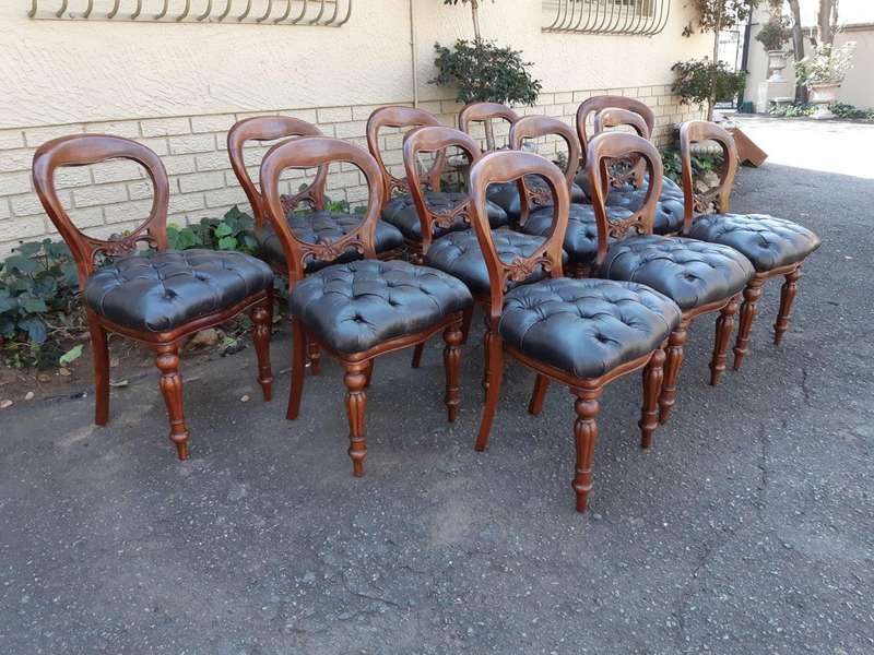 A 20TH Century Set of Twelve Victorian Style Mahogany Bustle Back Dining Chairs Upholstered in De...