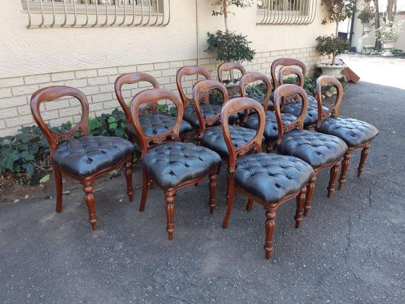 A 20TH Century Set of Twelve Victorian Style Mahogany Bustle Back Dining Chairs Upholstered in De...