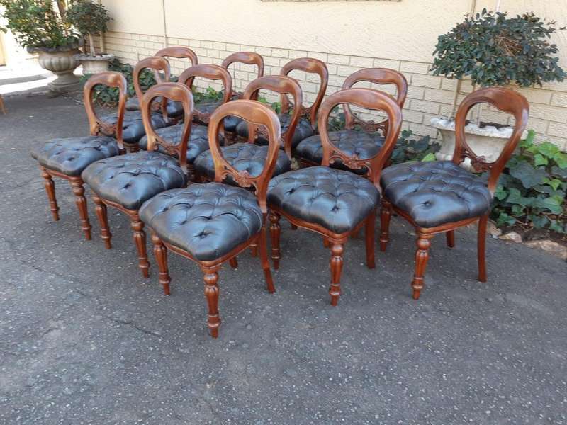 A 20TH Century Set of Twelve Victorian Style Mahogany Bustle Back Dining Chairs Upholstered in De...