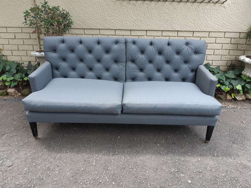 A Designer Sofa in a Grey Imported Waterproof and Stain Resistant Fabric. Condition is as new.