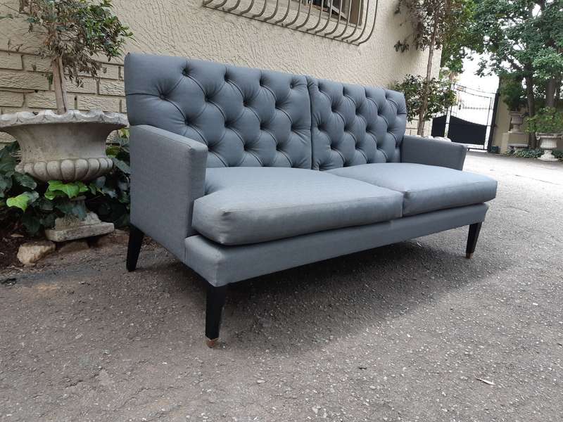 A Designer Sofa in a Grey Imported Waterproof and Stain Resistant Fabric. Condition is as new.