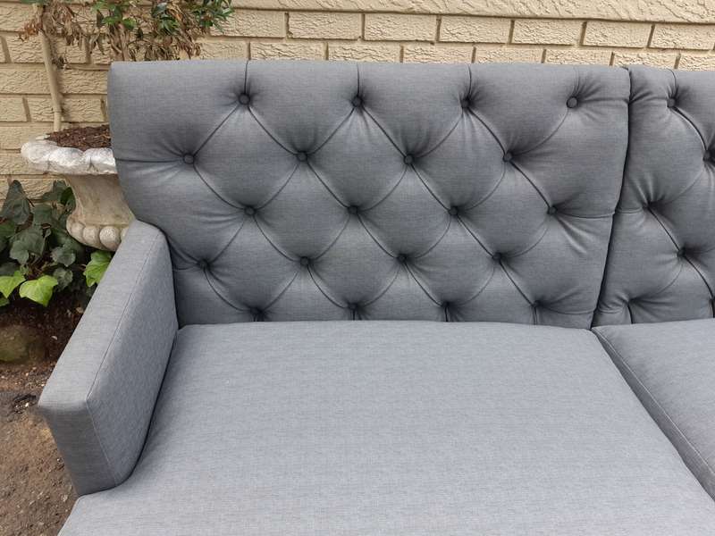 A Designer Sofa in a Grey Imported Waterproof and Stain Resistant Fabric. Condition is as new.
