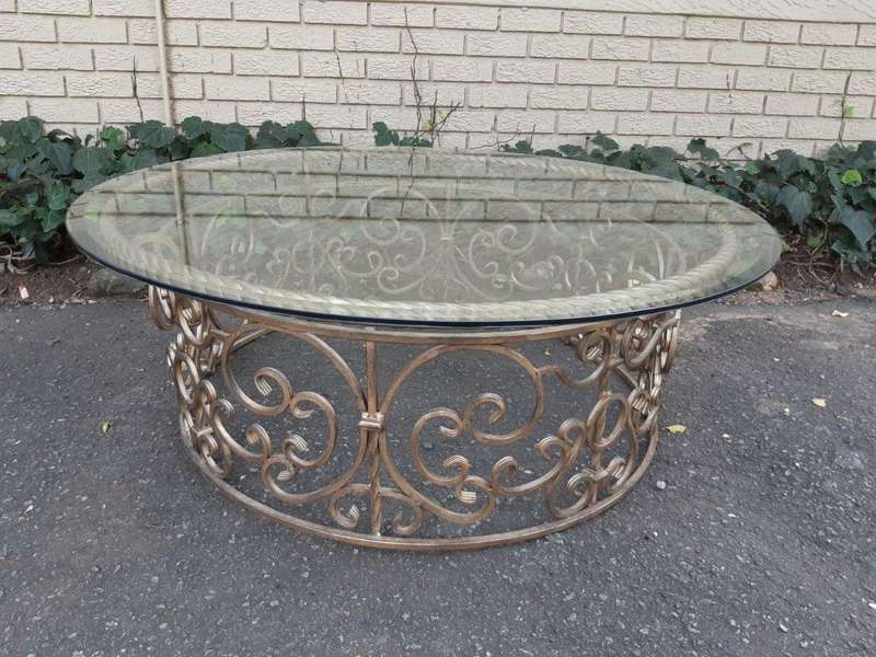 Round wrought iron coffee table with glass top with thick bevelled glass top