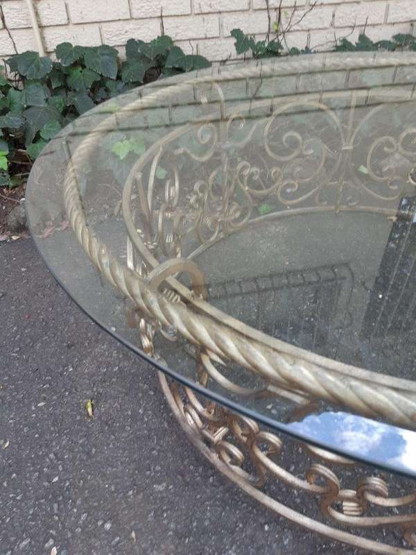 Round wrought iron coffee table with glass top with thick bevelled glass top
