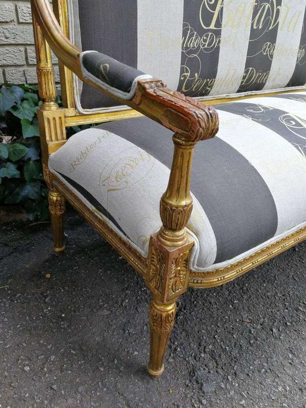 A 20th Century French Style Ornate Hand-Carved and Gilded Settee / Sofa Upholstered in a Custom-m...
