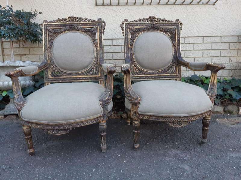 A 20th Century Pair (over 80 years old) of French Style Ornately Carved and Gilded Arm Chairs Uph...