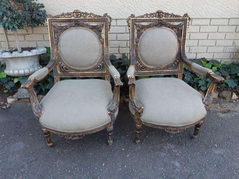 A 20th Century Pair (over 80 years old) of French Style Ornately Carved and Gilded Arm Chairs Uph...