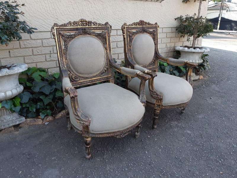 A 20th Century Pair (over 80 years old) of French Style Ornately Carved and Gilded Arm Chairs Uph...