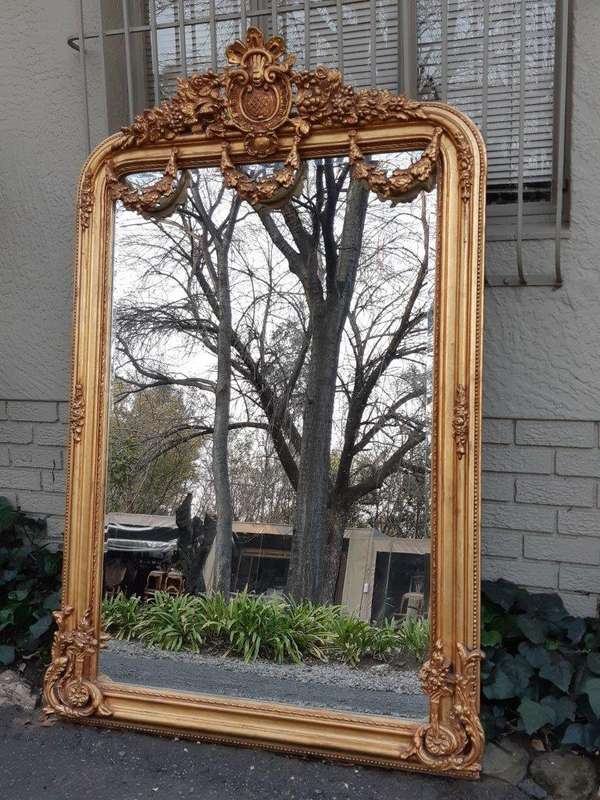 An Ornate and of Large Proportion Giltwood Bevelled Mirror