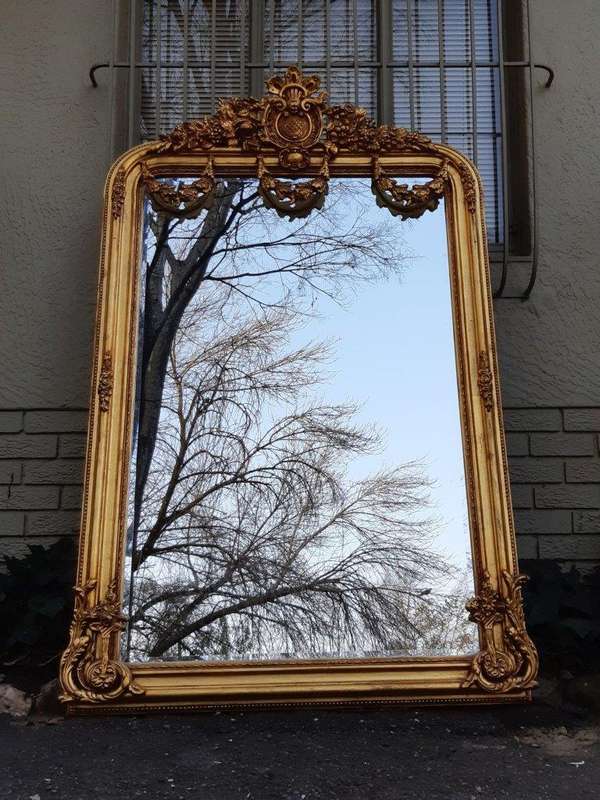 An Ornate and of Large Proportion Giltwood Bevelled Mirror