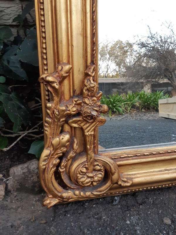 An Ornate and of Large Proportion Giltwood Bevelled Mirror