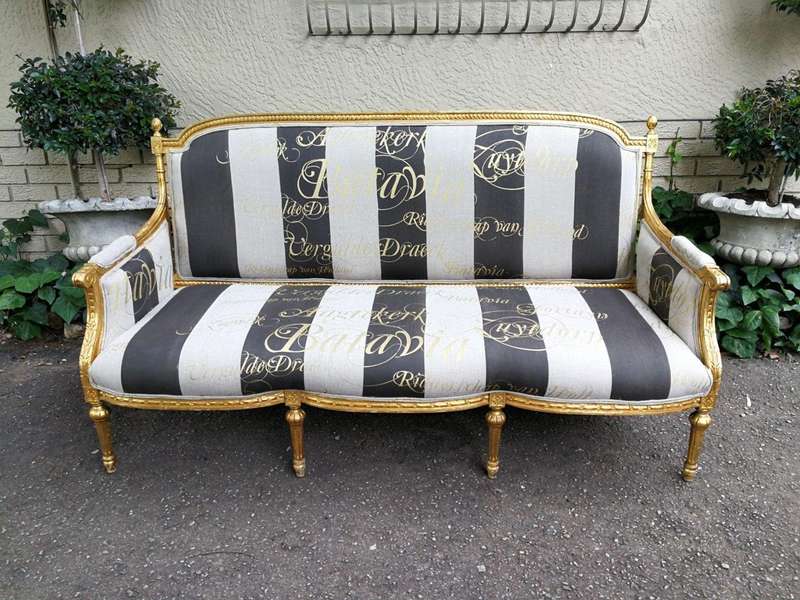 A French Antique Hand-Carved And Gilded Settee, Upholstered In A Hand Painted Imported Linen Fabr...