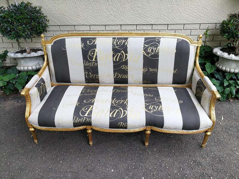 A French Antique Hand-Carved And Gilded Settee, Upholstered In A Hand Painted Imported Linen Fabr...