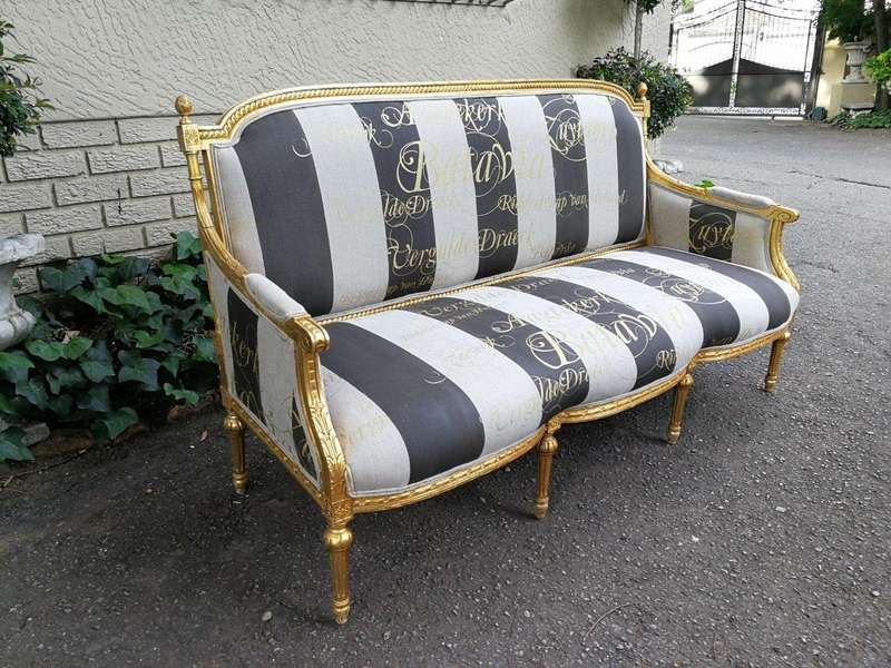 A French Antique Hand-Carved And Gilded Settee, Upholstered In A Hand Painted Imported Linen Fabr...