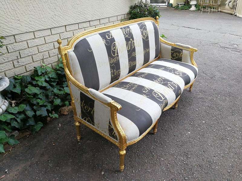 A French Antique Hand-Carved And Gilded Settee, Upholstered In A Hand Painted Imported Linen Fabr...