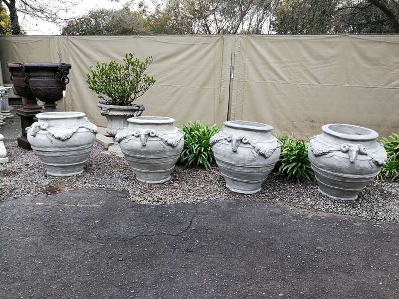 A Set of Four (4) VERY LARGE hand-painted concrete rams heads jardinieres/urns