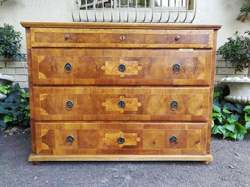 A Walnut And Inlaid Chest-Of-Drawers, 19th Century