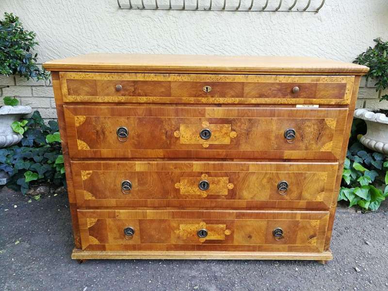 A Walnut And Inlaid Chest-Of-Drawers, 19th Century