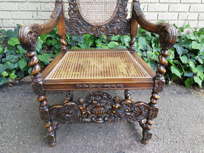 19th Century Ornately Carved Flemish Throne Chair With Rattan Back And Seat