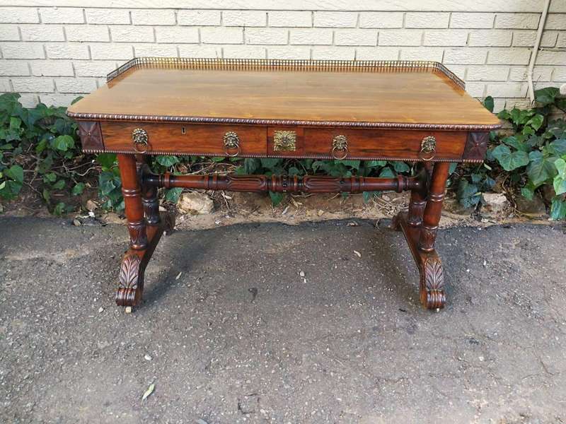 A William IV Rosewood Library Table With Brass Gallery On Brass Castors