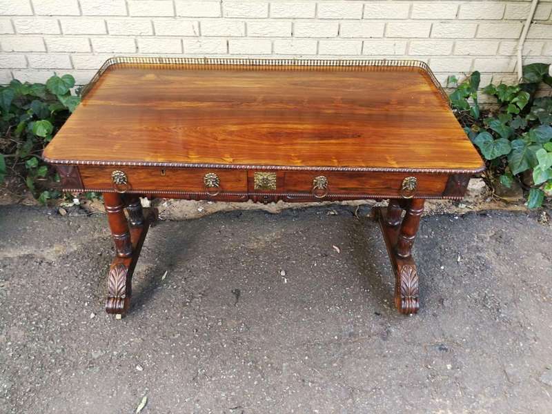A William IV Rosewood Library Table With Brass Gallery On Brass Castors