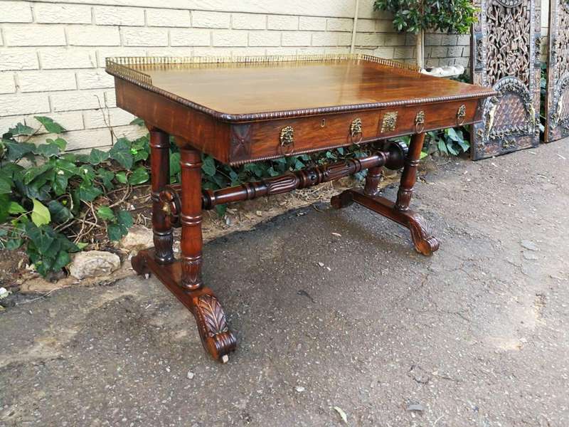A William IV Rosewood Library Table With Brass Gallery On Brass Castors