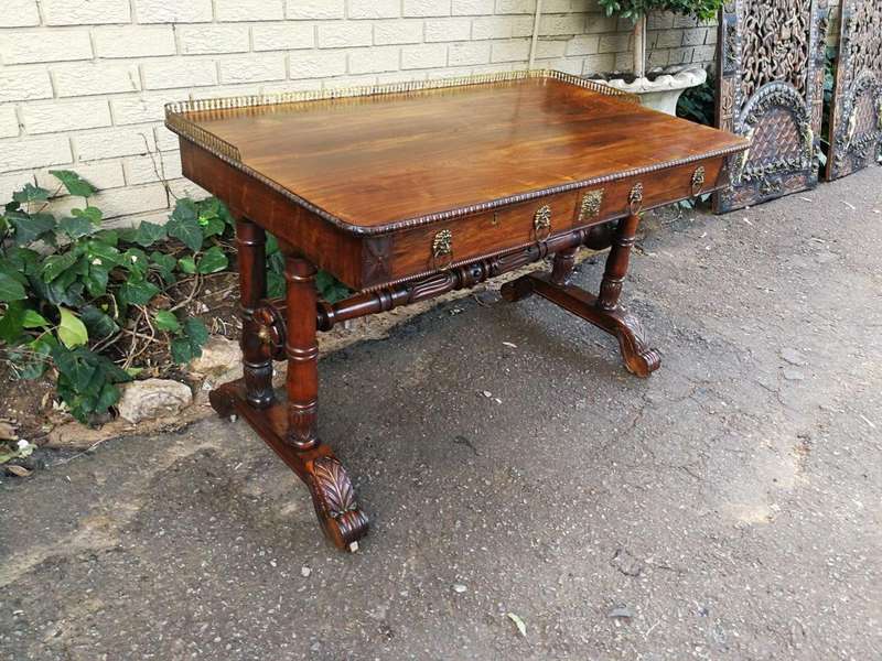 A William IV Rosewood Library Table With Brass Gallery On Brass Castors