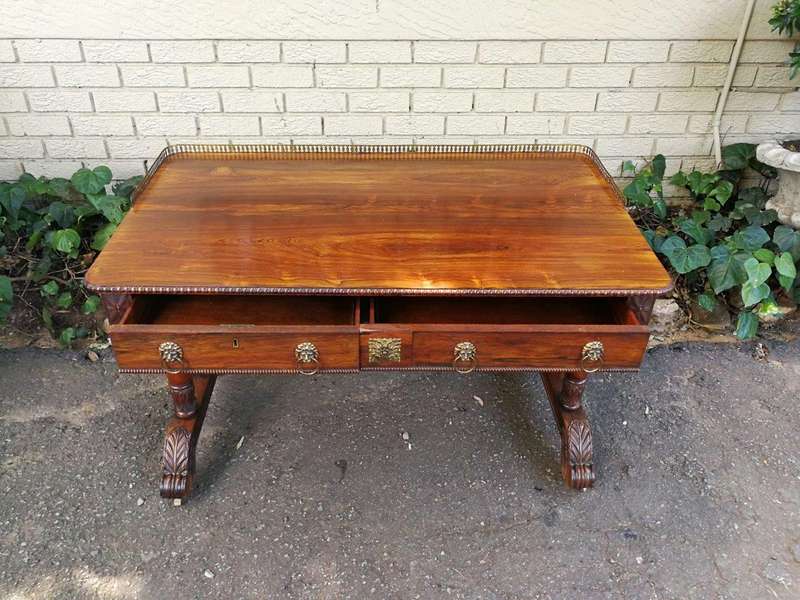 A William IV Rosewood Library Table With Brass Gallery On Brass Castors