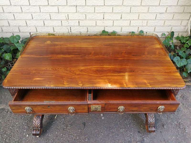 A William IV Rosewood Library Table With Brass Gallery On Brass Castors