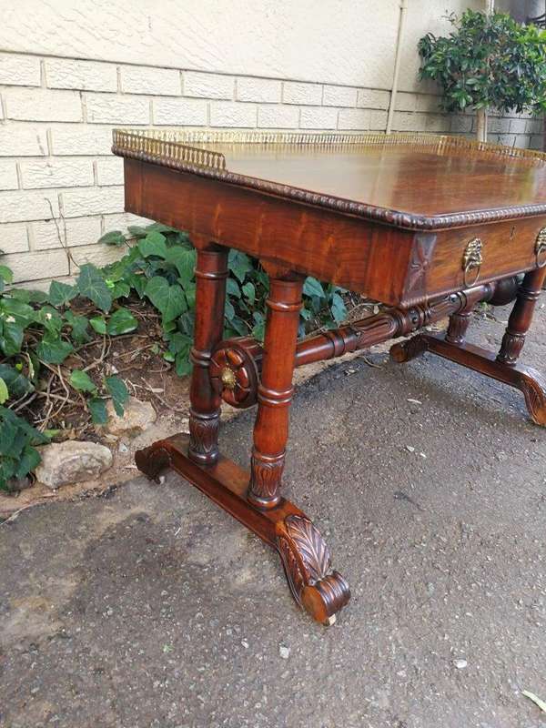 A William IV Rosewood Library Table With Brass Gallery On Brass Castors
