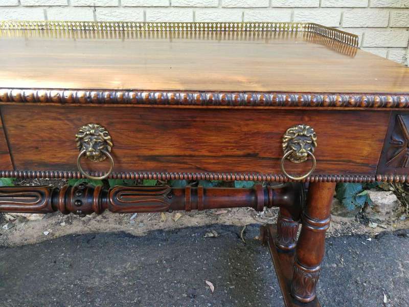A William IV Rosewood Library Table With Brass Gallery On Brass Castors