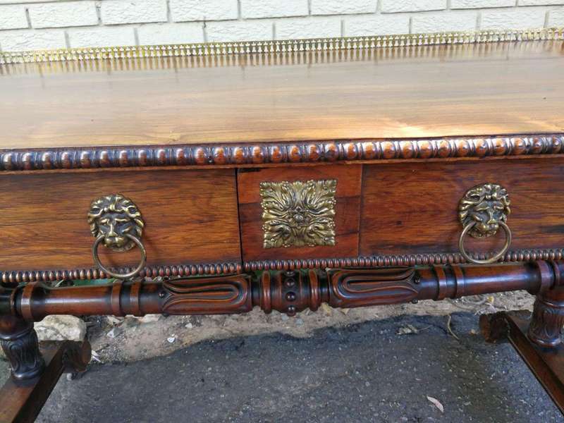 A William IV Rosewood Library Table With Brass Gallery On Brass Castors