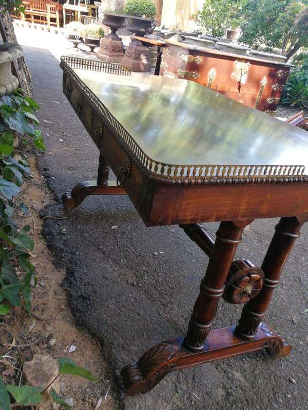 A William IV Rosewood Library Table With Brass Gallery On Brass Castors