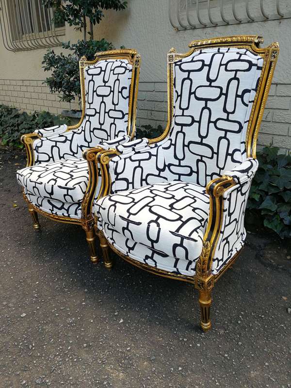 A Pair of Late 19th Century French Bergere Chairs Hand Gilded with Gold Leaf and Upholstered in i...