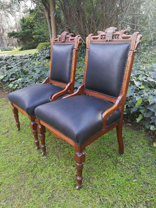 A Late 19th Century Pair of Victorian Carved Walnut Chairs Upholstered in Leather on Casters