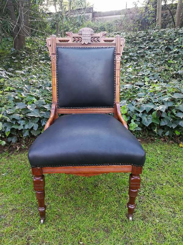 A Late 19th Century Pair of Victorian Carved Walnut Chairs Upholstered in Leather on Casters