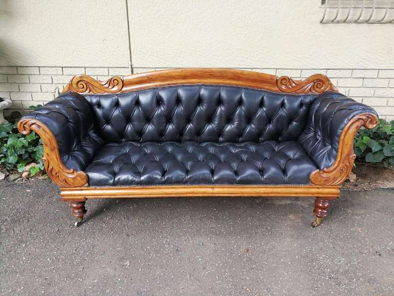 Victorian Mahogany Settee Upholstered In Deep-Buttoned Leather. Original Porcelain Casters