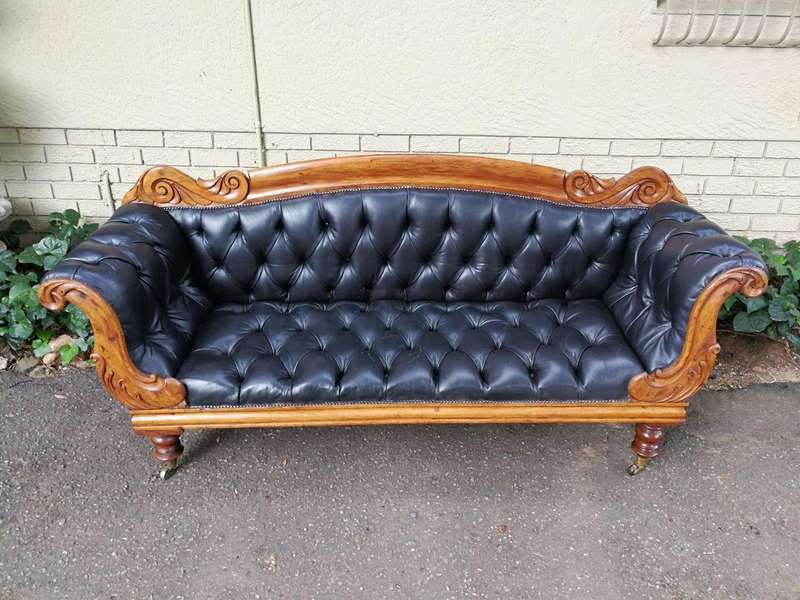 Victorian Mahogany Settee Upholstered In Deep-Buttoned Leather. Original Porcelain Casters