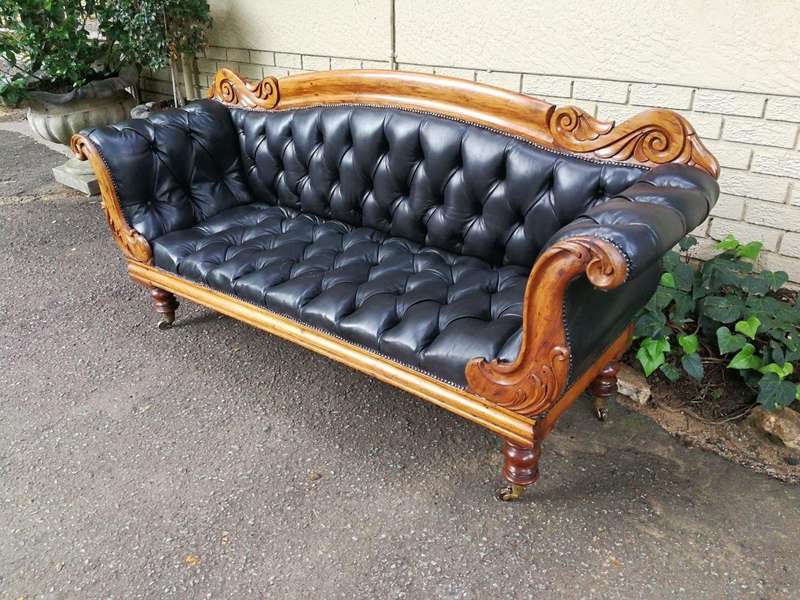 Victorian Mahogany Settee Upholstered In Deep-Buttoned Leather. Original Porcelain Casters