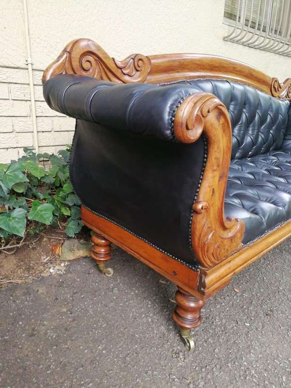 Victorian Mahogany Settee Upholstered In Deep-Buttoned Leather. Original Porcelain Casters