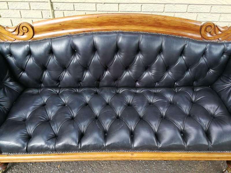 Victorian Mahogany Settee Upholstered In Deep-Buttoned Leather. Original Porcelain Casters