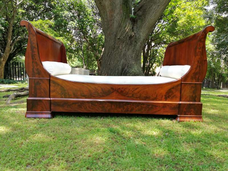 A French Flame Mahogany Lit-En-Bateau / Daybed on Wooden Castors. Circa 1950